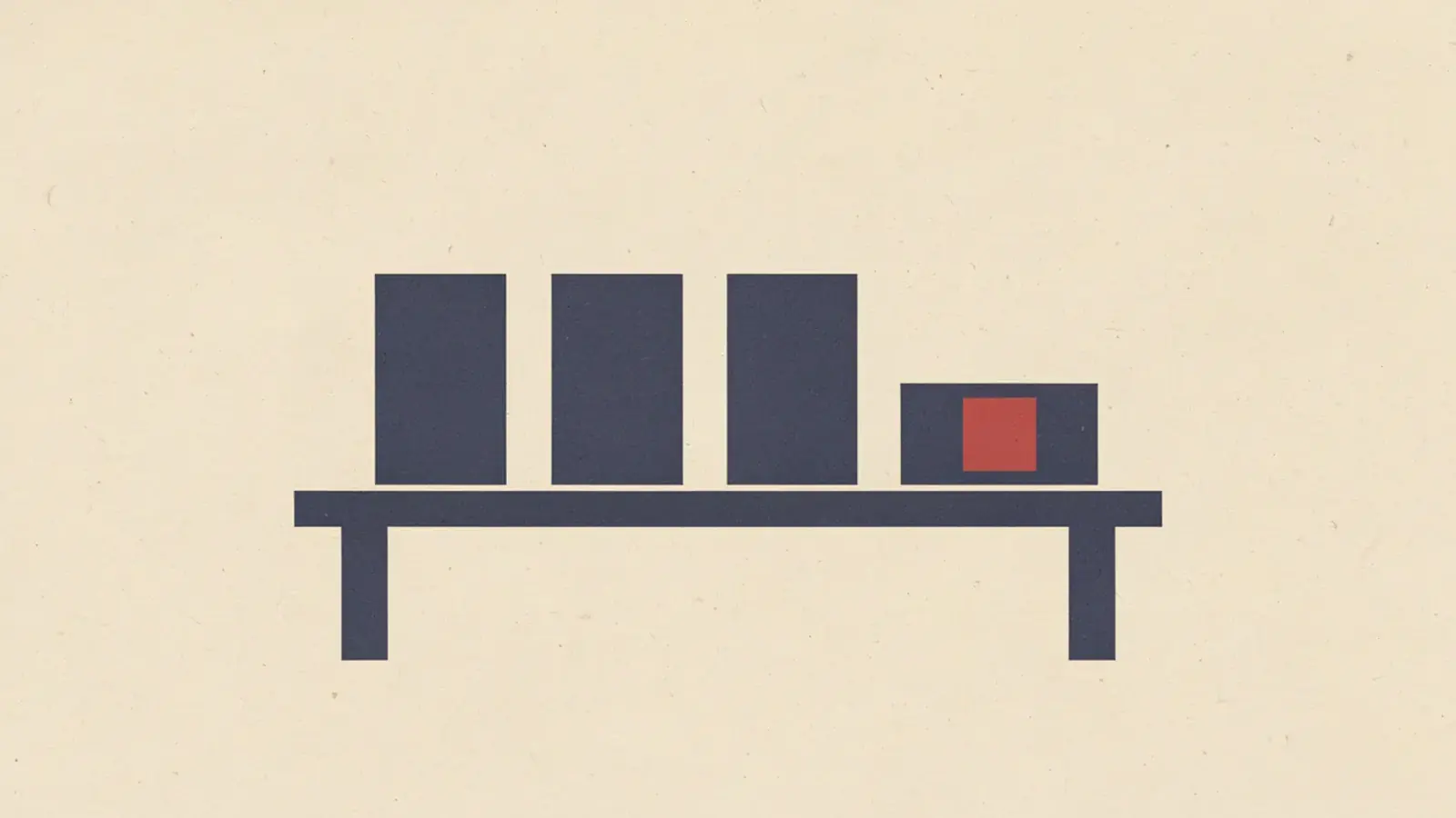 Three plain dark blue blocks standing on a shelf, and a fourth smaller block beside them with a red square set into its face.